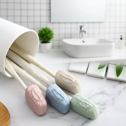 Set of pastel-colored soap bars with wooden spoons on a marble surface.